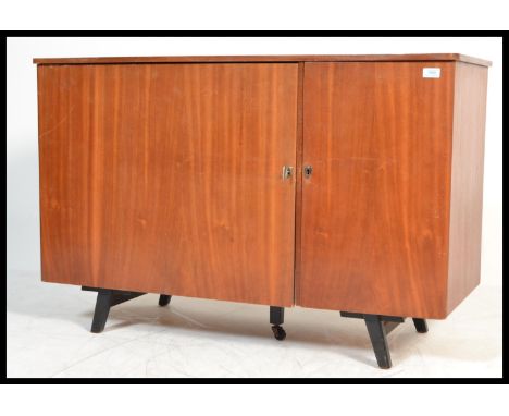 A vintage retro 20th century Danish influence teak metamorphic desk having opening action front that reveals a knee hole rece