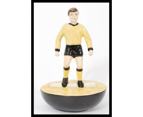 A Royal Doulton Subbuteo ceramic football figurine MCL 12 featuring a player in black and yellow kit on black and yellow base