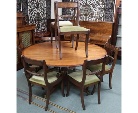 A 20th century mahogany extending dining table and eight chairs, dining table with circular top with perimeter mounting leave