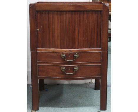 A 19th century mahogany bow front commode with galleried top over tambour door over two faux drawers concealing pull out comm