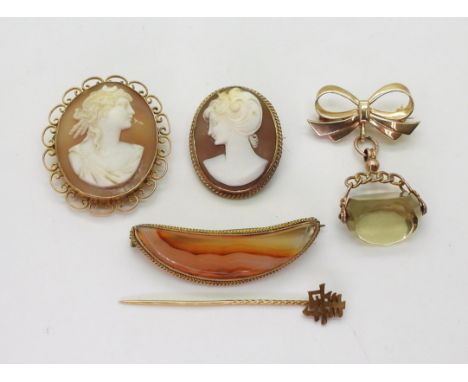 An agate brooch mounted in yellow metal, together with a Chinese symbol yellow metal pin, two cameo brooches and a 9ct gold c