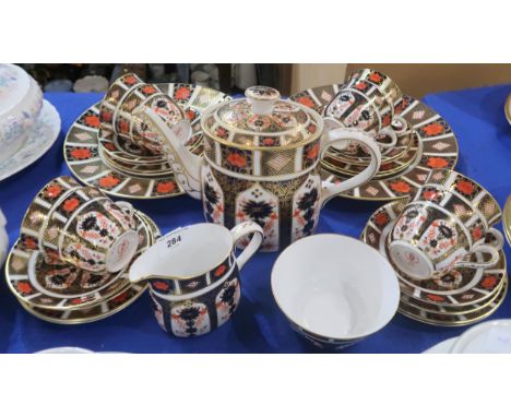 A Royal Crown Derby 1128 imari teaset comprising teapot, eight cups, saucers, plates, two cake plates, milk jug and sugar bow