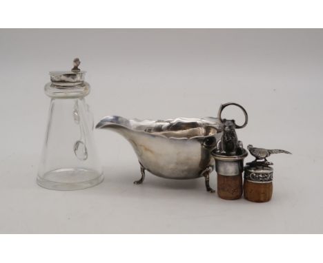 A silver sauce boat, my James &amp; William Deakin, Birmingham, on three pad feet, a silver pheasant bottle stopper, a silver