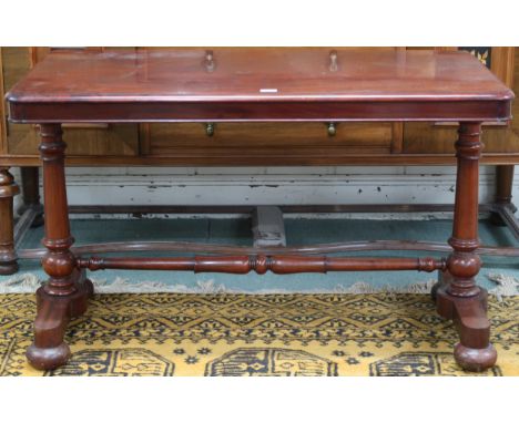 A Victorian mahogany hall table with rectangular top on pair of turned column supports joined by turned stretcher on bun feet