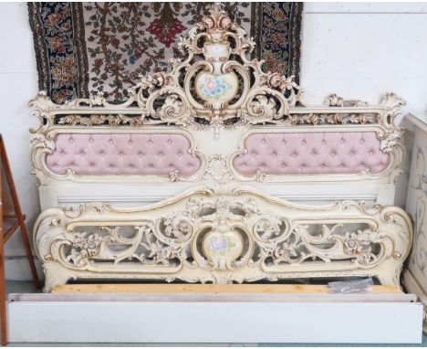 A 20th century Louis XVI style cream and gilt painted super king sized bedframe with button upholstered Rococo style headboar