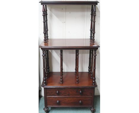 A Victorian mahogany what-not with two open shelves separated buy turned supports over two drawers on turned supports termina