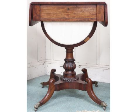 A Victorian mahogany drop end sewing/work table with single drawer over slide hamper on carved turned column terminating in q