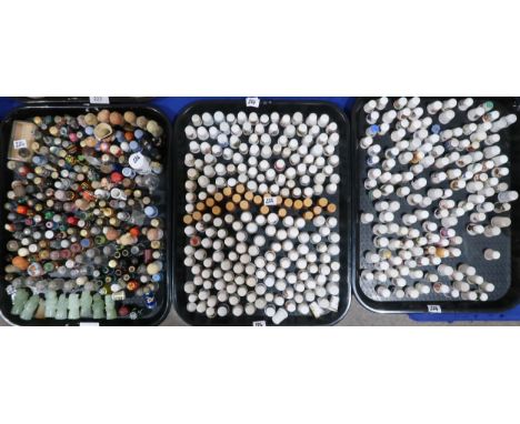 A collection of thimbles including six Australian silver mounted glass examples, Royal Doulton flambe, and others in wood, gl