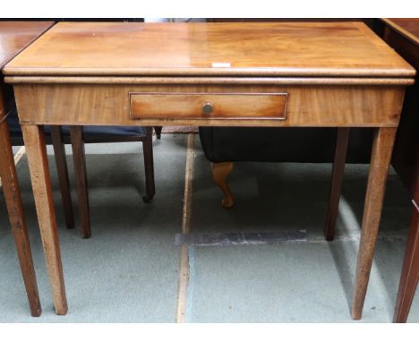 A Victorian mahogany fold-over card table with rectangular top concealing baize lined play surface over single drawer on squa