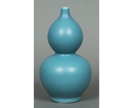 A Chinese porcelain double gourd vaseWith allover blue glaze, the underside with impressed seal mark.  22.5 cm high.   CONDIT