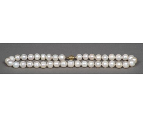 A pearl necklaceSet with a 14 K gold clasp.  44 cm long.    CONDITION REPORTS:  Generally in good condition, some general wea