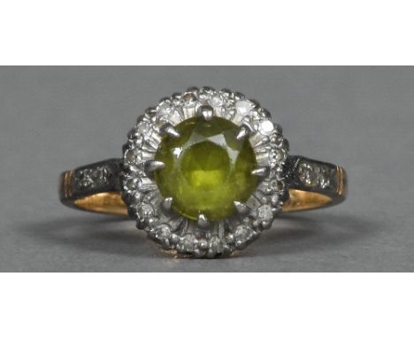 An 18 ct gold diamond and peridot flowerhead ring   CONDITION REPORTS:  Some general surface wear, dirty, ring size K/L.