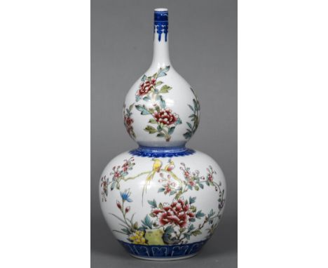 A Chinese porcelain vaseOf double gourd form, decorated with birds amongst foliage, the reverse with calligraphic decorations