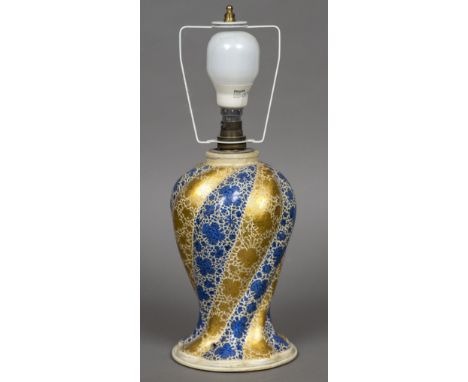 An Indian Kashmiri papier mache lamp baseSpiral moulded and decorated with blue and gilt strapwork, paper label to underside.