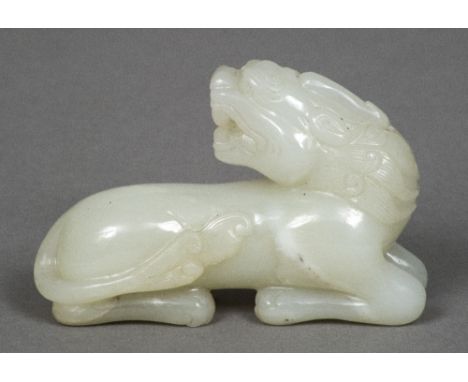 A Chinese carved celadon jade temple lionWorked in recumbent pose.  8.5 cm long.    CONDITION REPORTS:  Generally in good con