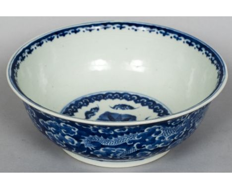 A Chinese blue and white porcelain bowlDecorated with dragons amongst stylised clouds, blue painted six character Xianfeng se