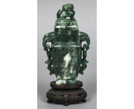 A Chinese carved spinach green jade vase and cover The removable cover mounted with a dog-of-fo, the main body with twin mask