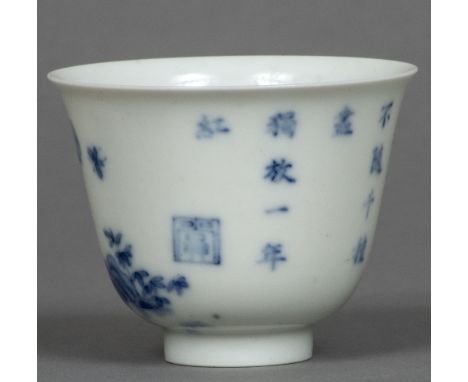 A Chinese blue and white eggshell porcelain wine cupDecorated with insects amongst floral sprays opposing calligraphic text a