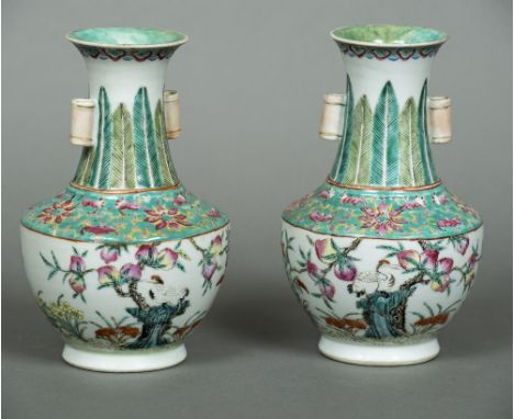 A pair of Chinese porcelain vasesEach lappet decorated neck with twin lug handles over a band of bat and floral filled decora