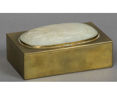 A Chinese brass boxOf rectangular form, the hinged lid inset with a domed jade panel decorated with a flowering vase.  14.5 c