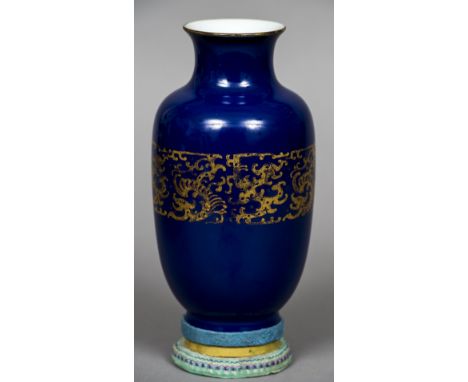 A Chinese porcelain powder blue vase, possibly 19th centuryDecorated with an archaistic gilt band, standing on an embroidery 