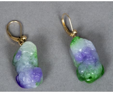 A pair of Chinese 14 K gold mounted apple green and lavender jade earrings Each carved as a shi-shi.  Each 2.75 cm long.    C