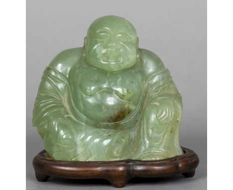 A carved jade model of BuddhaTypically modelled seated, mounted on a carved wooden plinth base; together with another model o