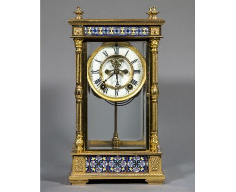 An American gilt metal and champleve enamelled four glass mantel clock The white dial with Roman numerals and exposed escapem