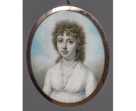 An early 19th century portrait miniature on ivoryDepicting a young girl with pearls in her hair, housed in an unmarked yellow