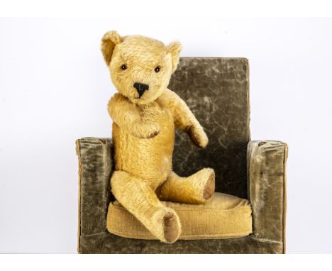 A Pedigree post-war teddy bear, with golden mohair, orange and black glass eyes, black stitched nose, swivel head, jointed li