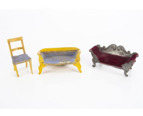 An interesting small scale dolls’ house tinplate sofa, similar to Evans &amp; Cartwright with embossed detail, scrolling arms