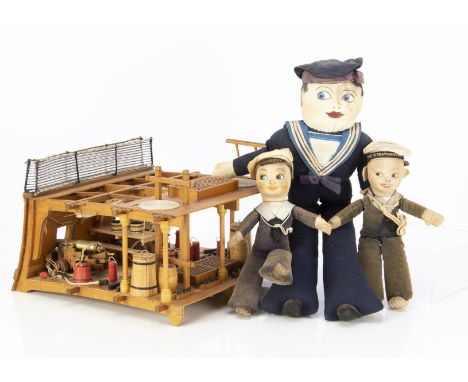Three cloth sailor dolls and a cross-section model of a gun deck on a 18th century battleship, the largest home-made doll mad