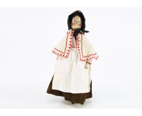 A late 19th century German pegged wooden doll,  with blue painted eyes, painted black hair with centre-parting, turned torso,