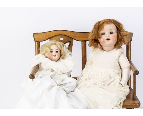 Two German character baby dolls, a Armand Marseilles 990 with blue sleeping eyes, nylon wig, composition body, white lace dre