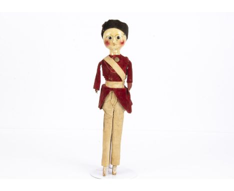 A rare late 18th century English carved and painted wooden British soldier doll,  with inset dark glass eyes with white glass
