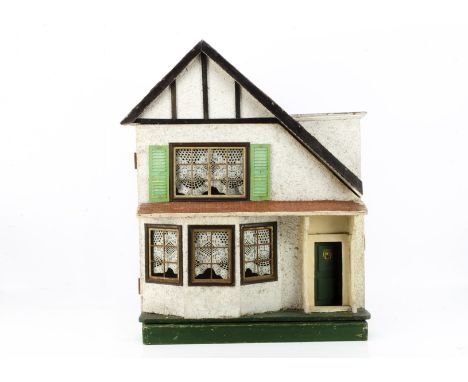 A Lines Bros Tri-ang asymmetrical dolls' house,  with white painted stippled façade, timbered eaves, green painted front door