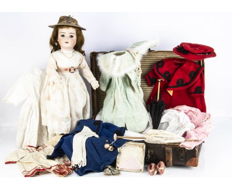 A Bruno Schmidt child doll with trousseau and provenance, with brown lashed sleeping eyes, pierced ears, brown mohair wig, jo