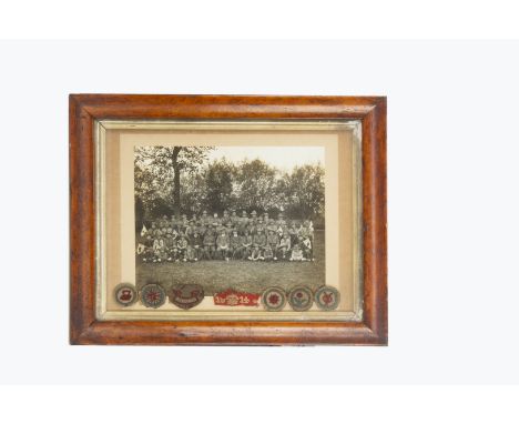 A large group photograph of a British Boy Scout troop circa 1914, in original wooden frame with a red 1914 Service Patch and 