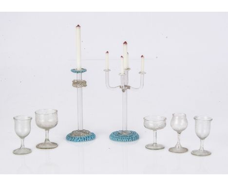 Five large scale dolls’ house wine glasses, clear with stems -1 1/2in. (3.5cm.) high; and two glass candlesticks