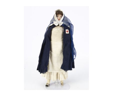 An interesting 1st World War composition Red Cross nurse, with painted face, brown mohair wig, socket head, straight limbs wi