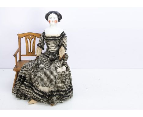 A large German china should head doll,  possibly by Alt, Beck &amp; Gottschalck with blue painted upward glancing eyes, black