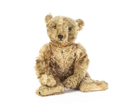 An early Steiff centre-seam teddy bear circa 1905, possibly a 35PAB with apricot golden mohair, black boot button nose, prono
