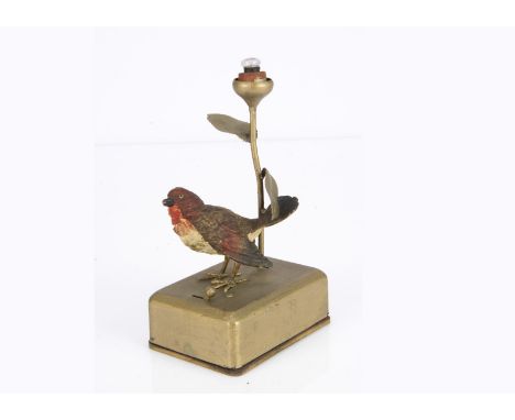 A German cast-metal robin lamp 1930s, standing on gold painted metal battery box with rose bud light behind -6 1/2in. (16.5cm