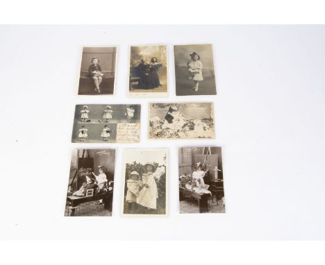 Doll and toy related postcards and photographs, seven real photograph postcards of girls with their dolls, ten postcards usin