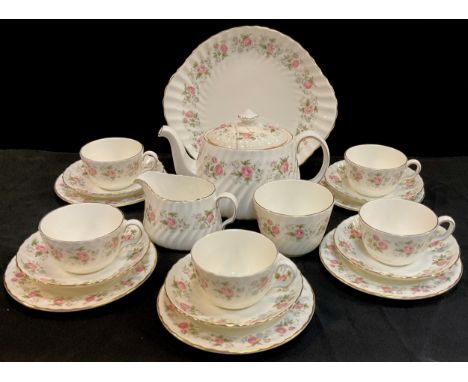 A Minton 'Spring Bouquet' pattern tea service for five comprised of; a tea pot, sugar bowl, milk jug, five tea cups and sauce