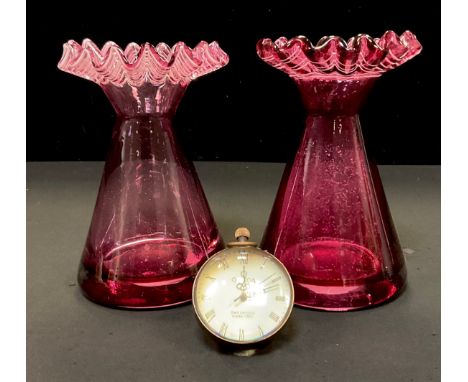 A glass ball magnification desk clock, 6cm diam, 6.5cm high over loop,  pair of cranberry glass vases (3) 