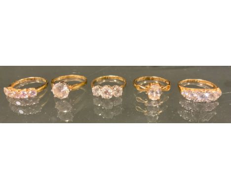 A 14ct gold DQCZ five stone dress ring, others three stone, oval solitaire, etc, all stamped 585,. sixes O-Q, 15.3g gross (5)