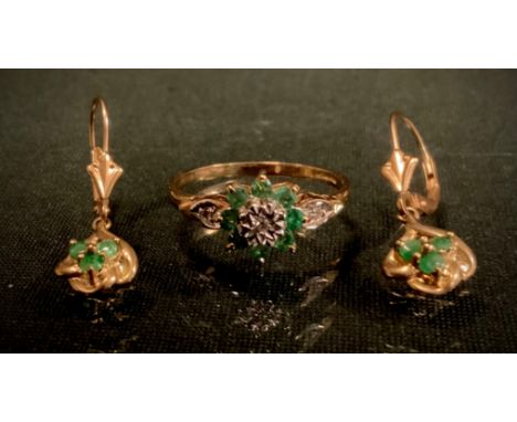 A diamond and emerald ring, set with three brilliant cut diamonds and eight emeralds, 9ct gold shank, size O, 1.8g gross;  pa