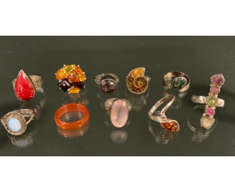 A silver mounted ammonite fossil ring, others rose quartz, coral, opal, ametrine, tourmaline, moss agate etc, with silver/ wh