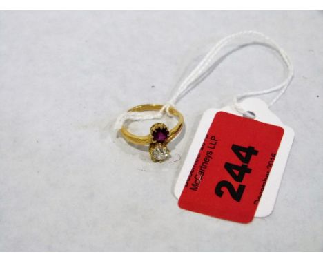 An 18ct ruby and diamond cross over ring. 3.1g. Size M